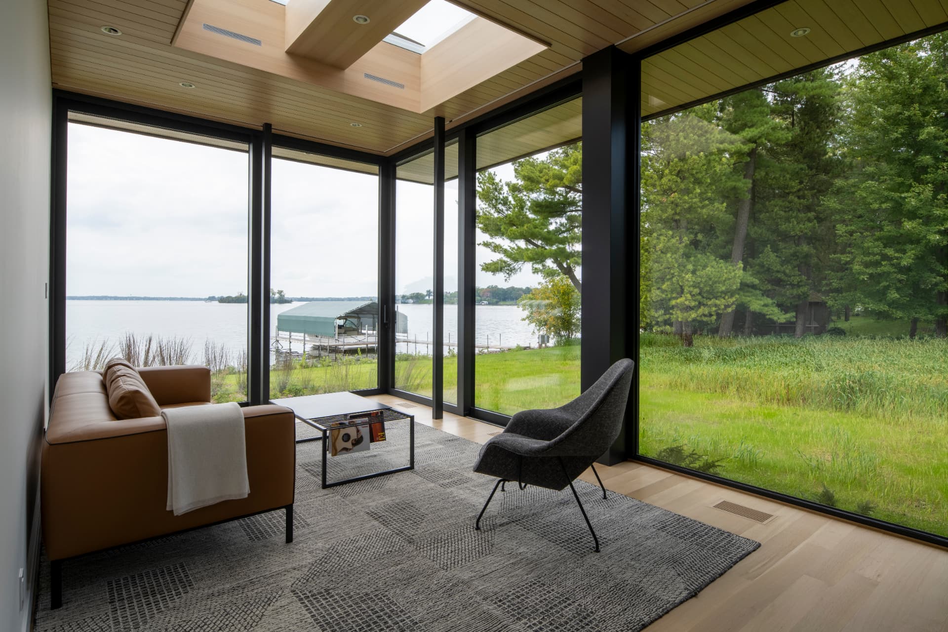 Shoreline Modern sitting room with panoramic lake views