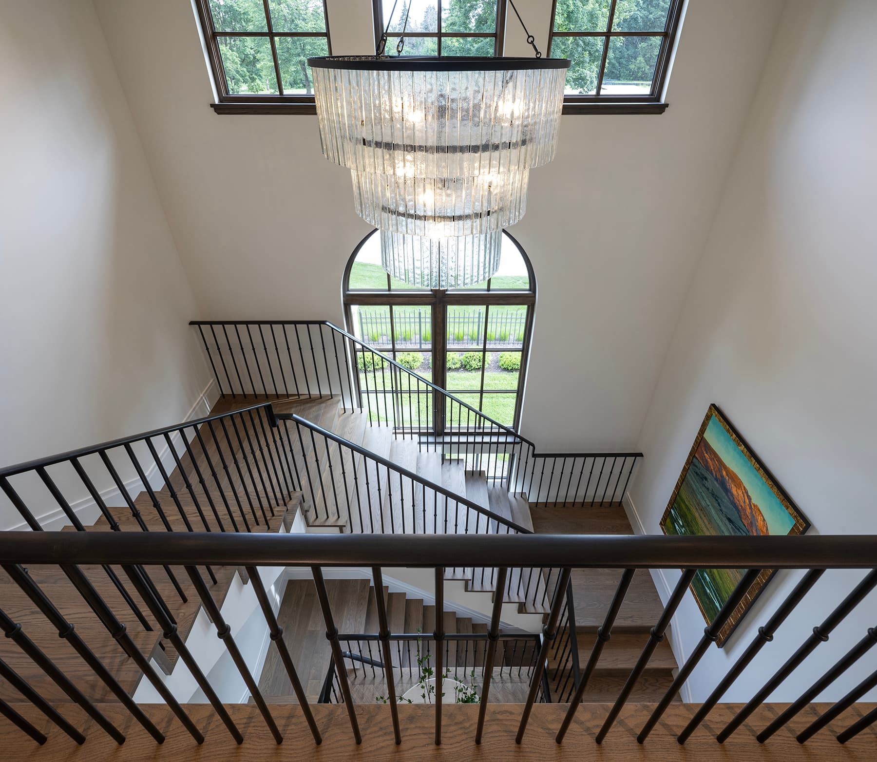 Highcroft three-story staircase with sculptural glass chandelier