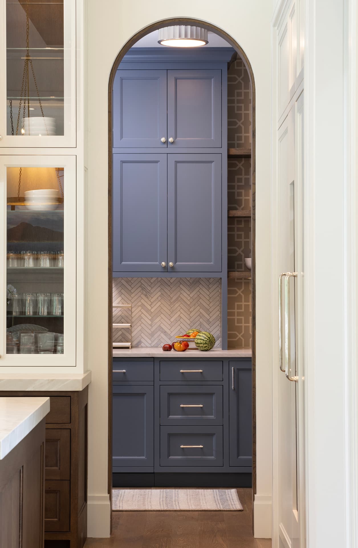 Highcroft arched blue pantry with marble countertop and fresh fruit