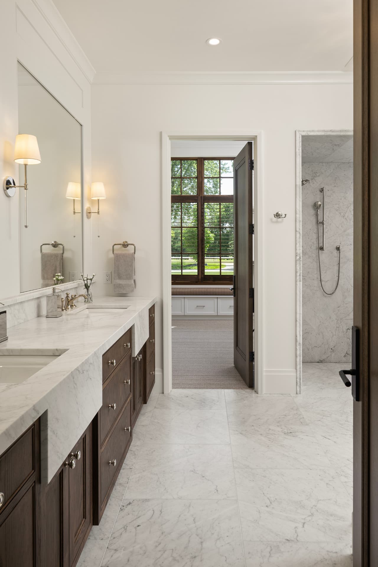Highcroft primary bath with marble counters and dark oak vanity