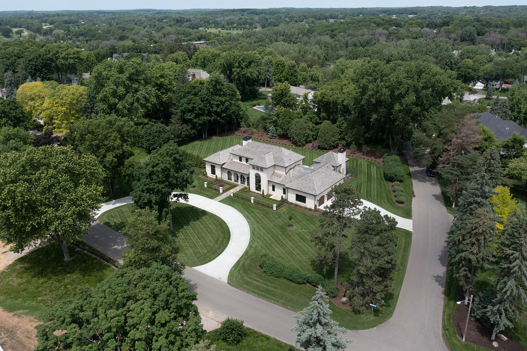 Aerial view of Highcroft within its wooded neighborhood