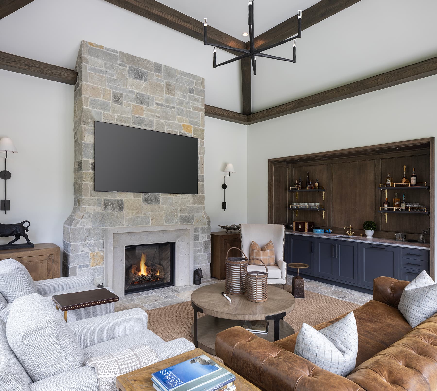 Highcroft lower lounge with stone fireplace, beamed ceiling and navy bar