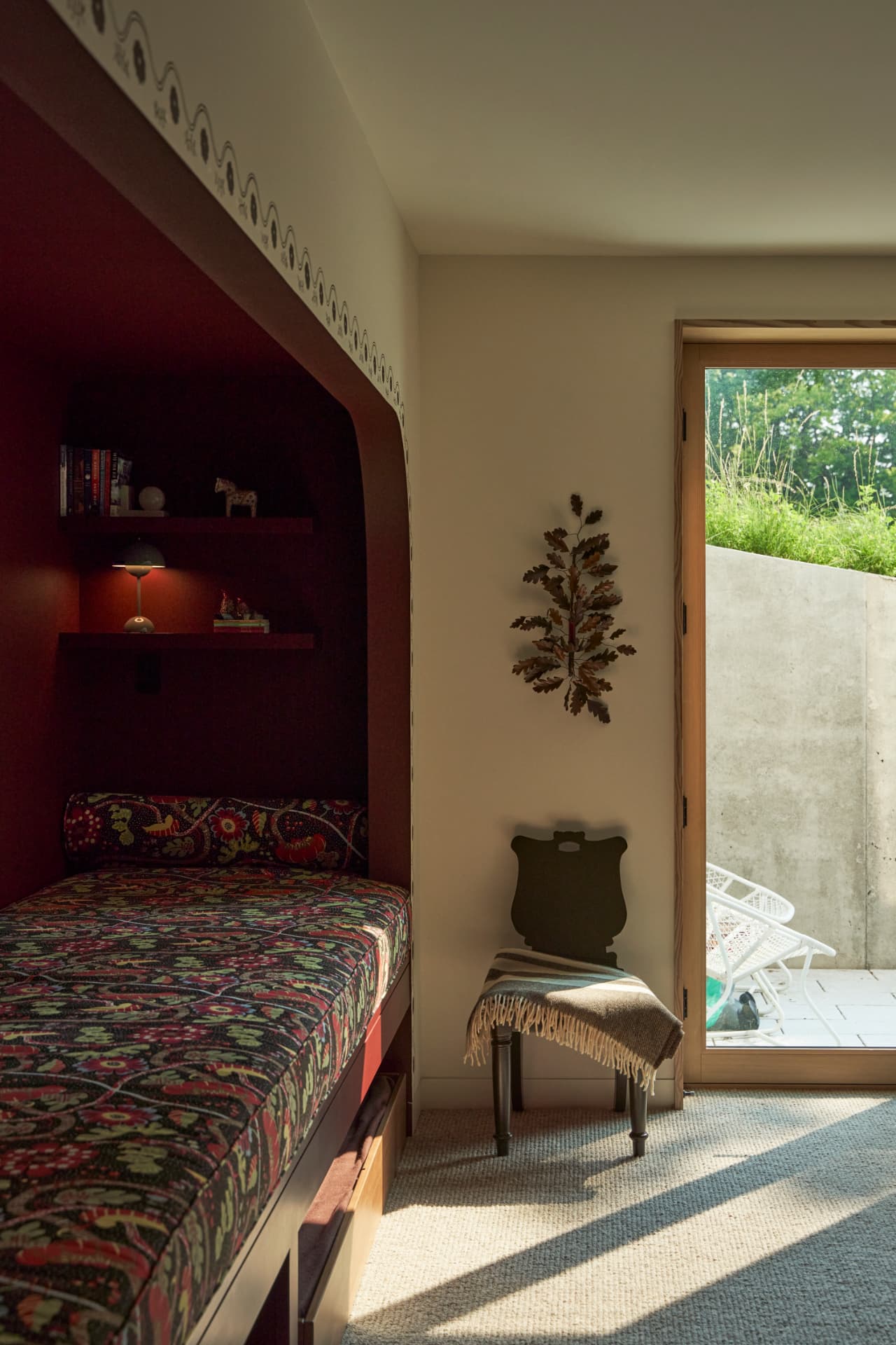 Hill House daybed nook with woven shades and cushions
