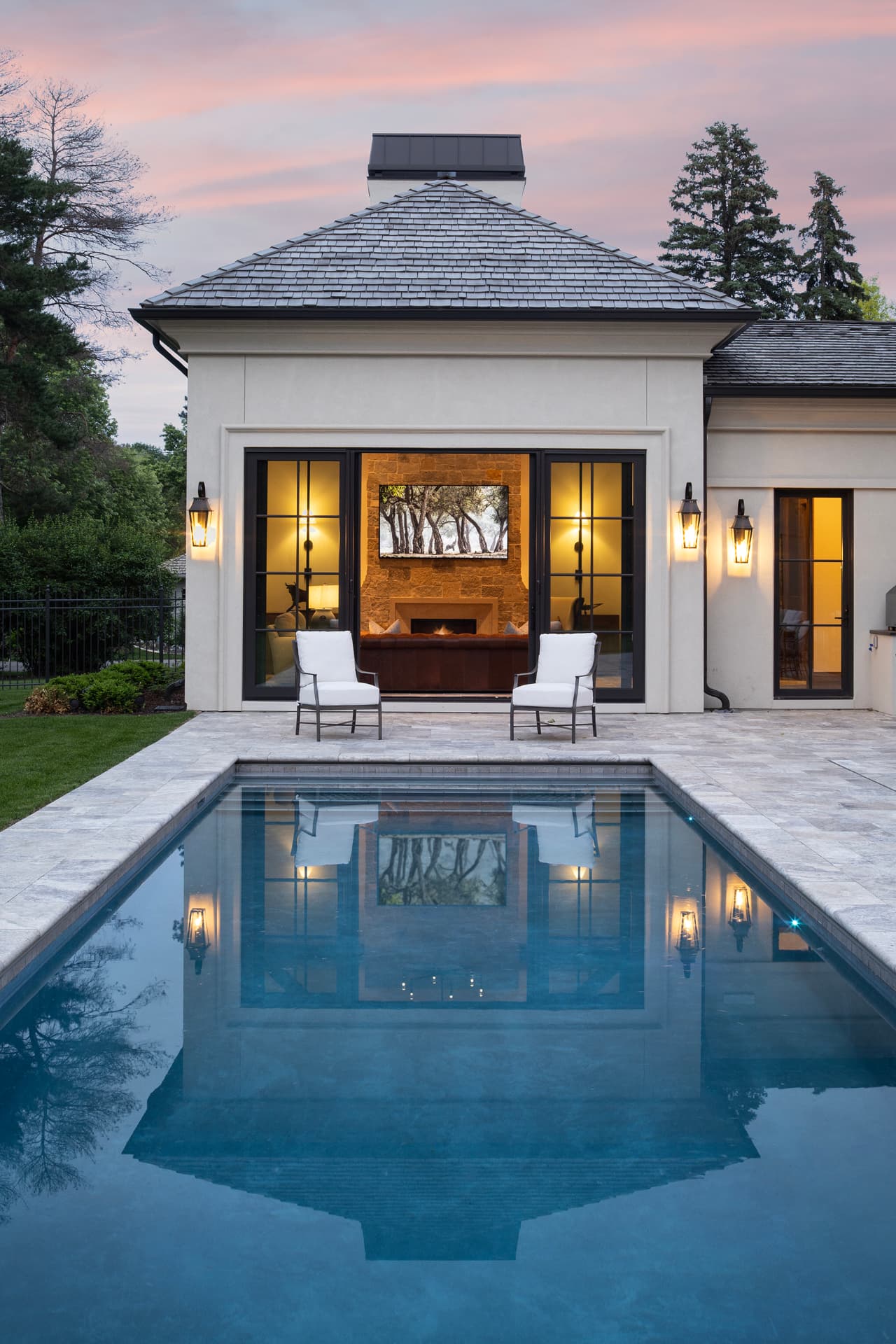 Highcroft pool house reflected in the lap pool at sunset