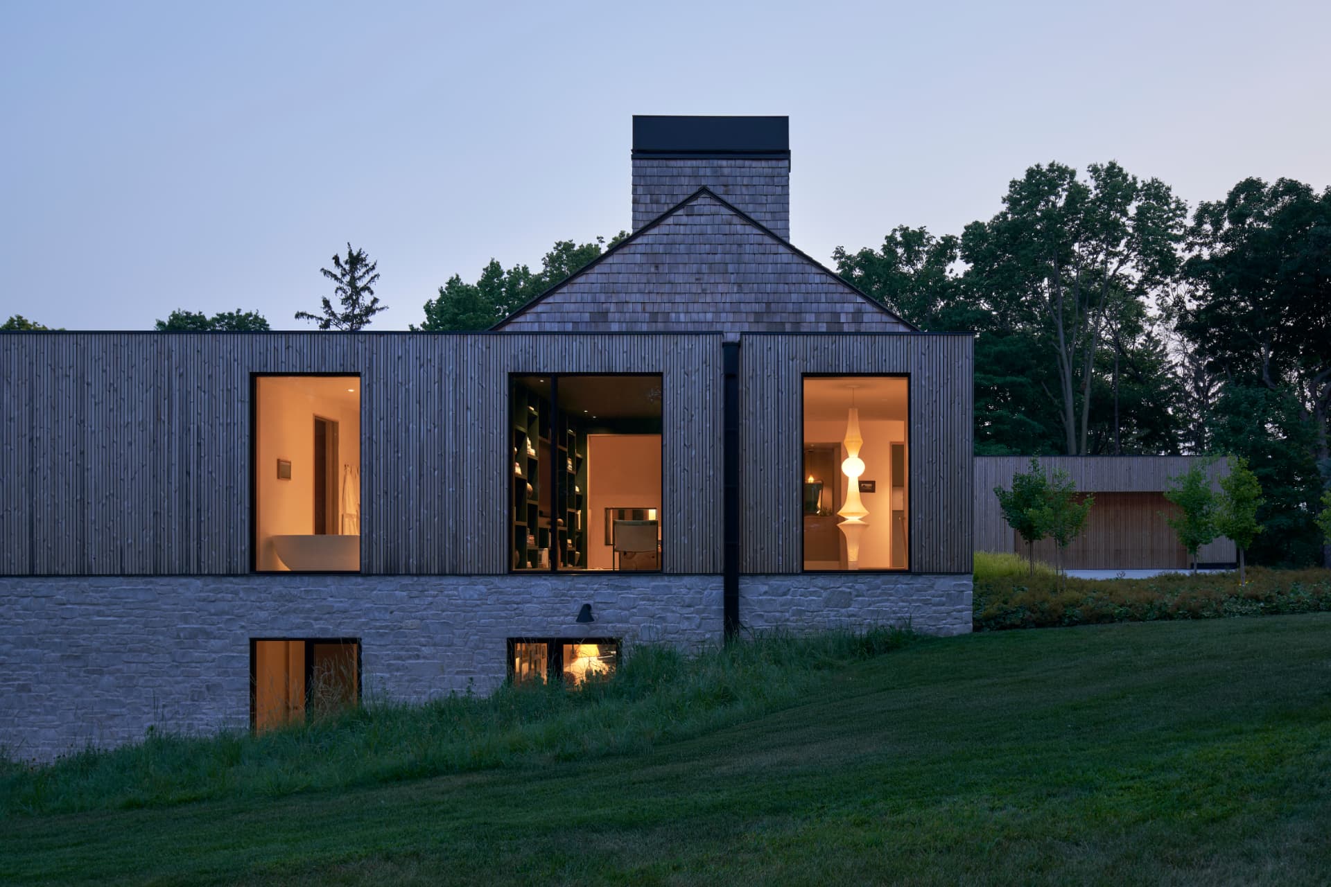 Hill House weathered cedar exterior at twilight