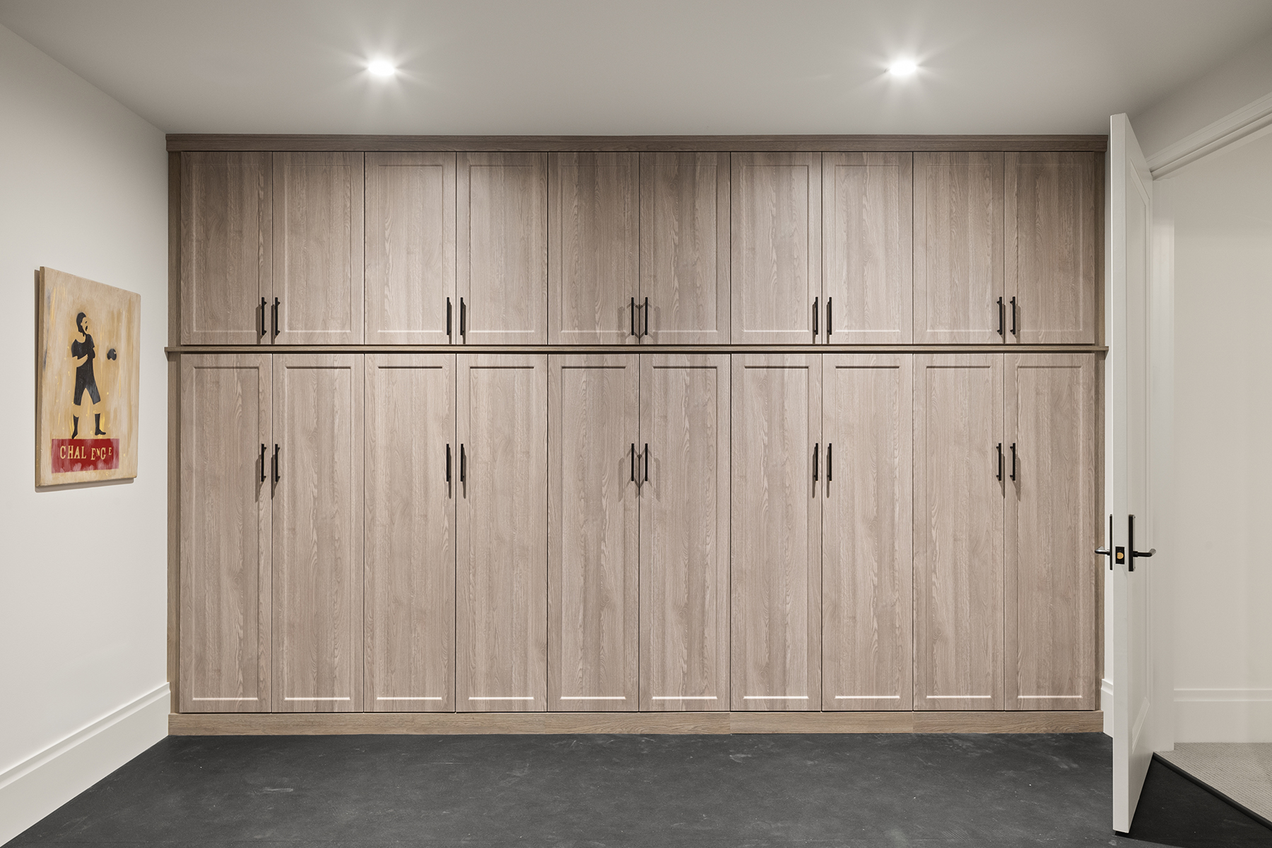 Highcroft gym storage wall in pale oak with vintage boxing artwork