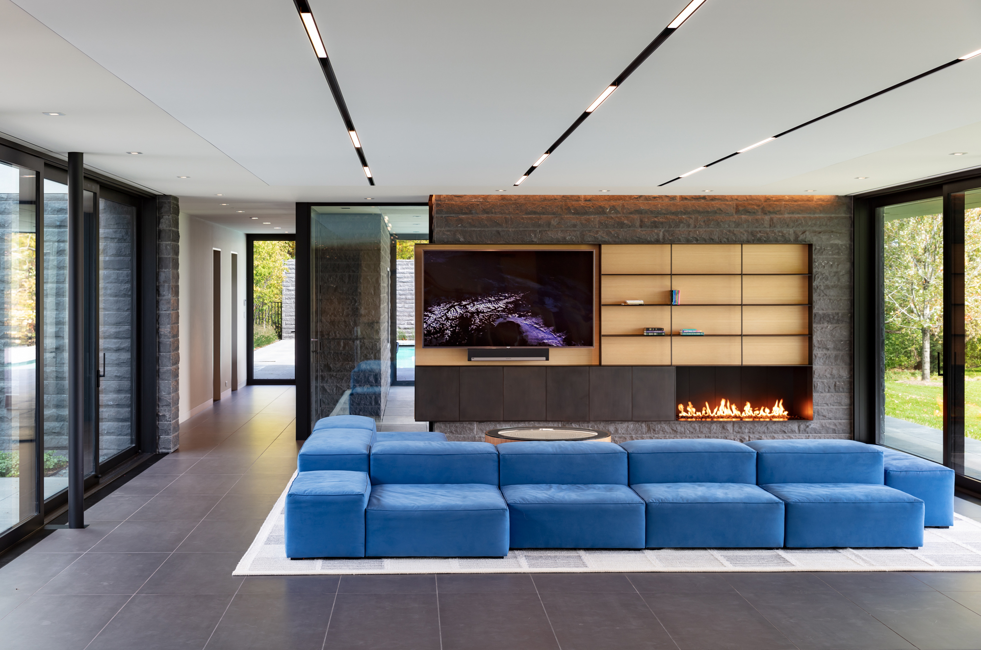 Bayside family room with blue sectional and fireplace