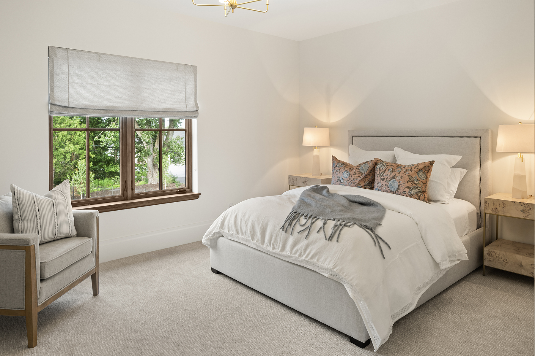 Highcroft bedroom in soft neutrals with treetop and lake views
