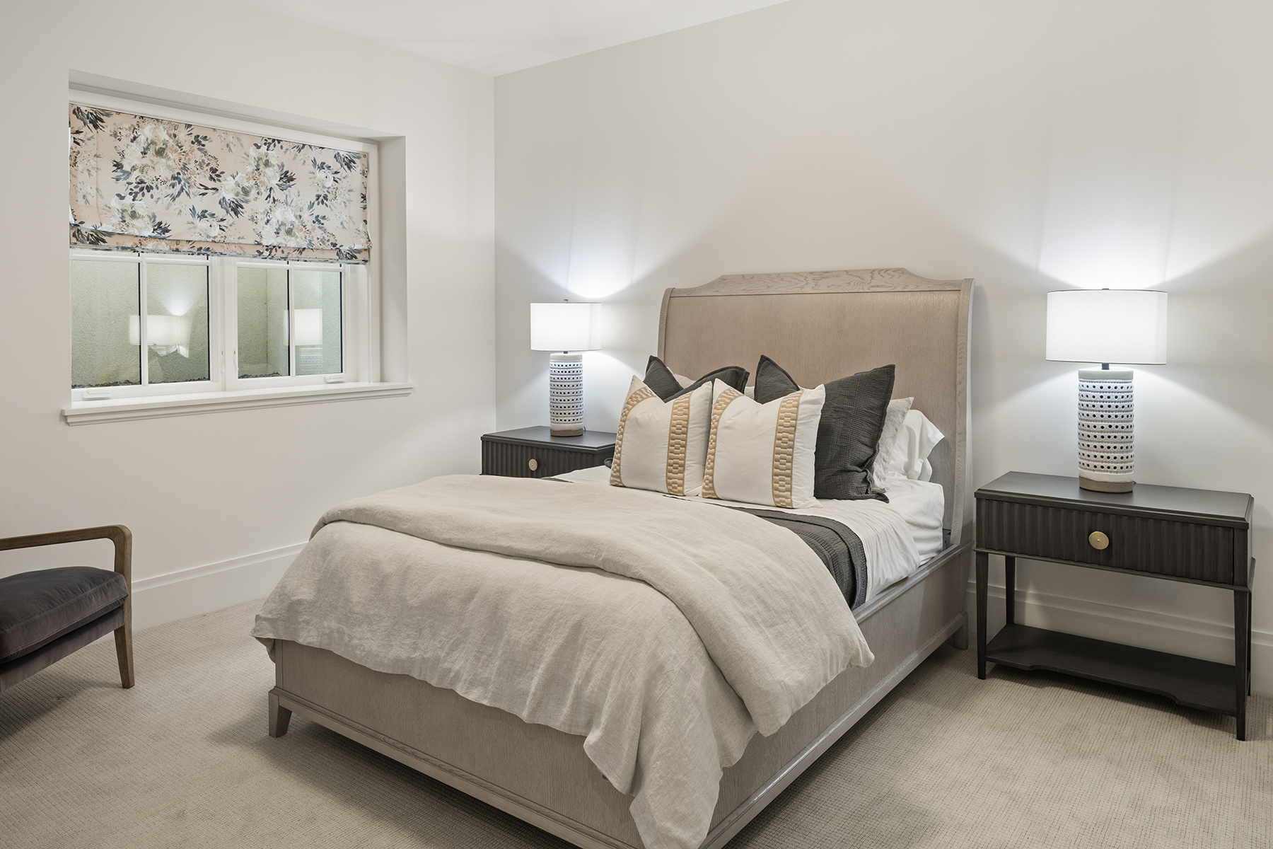 Highcroft lower-level guest bedroom with cerused sleigh bed and floral shade