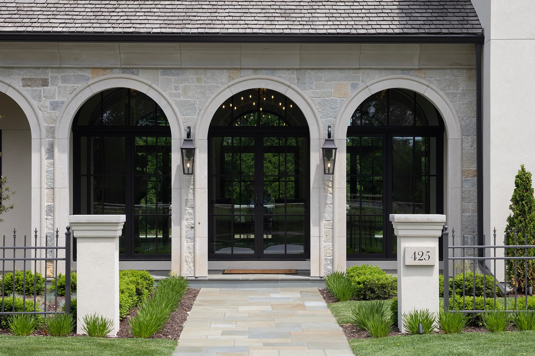 Highcroft stone entry arcade with lanterns and bluestone walk