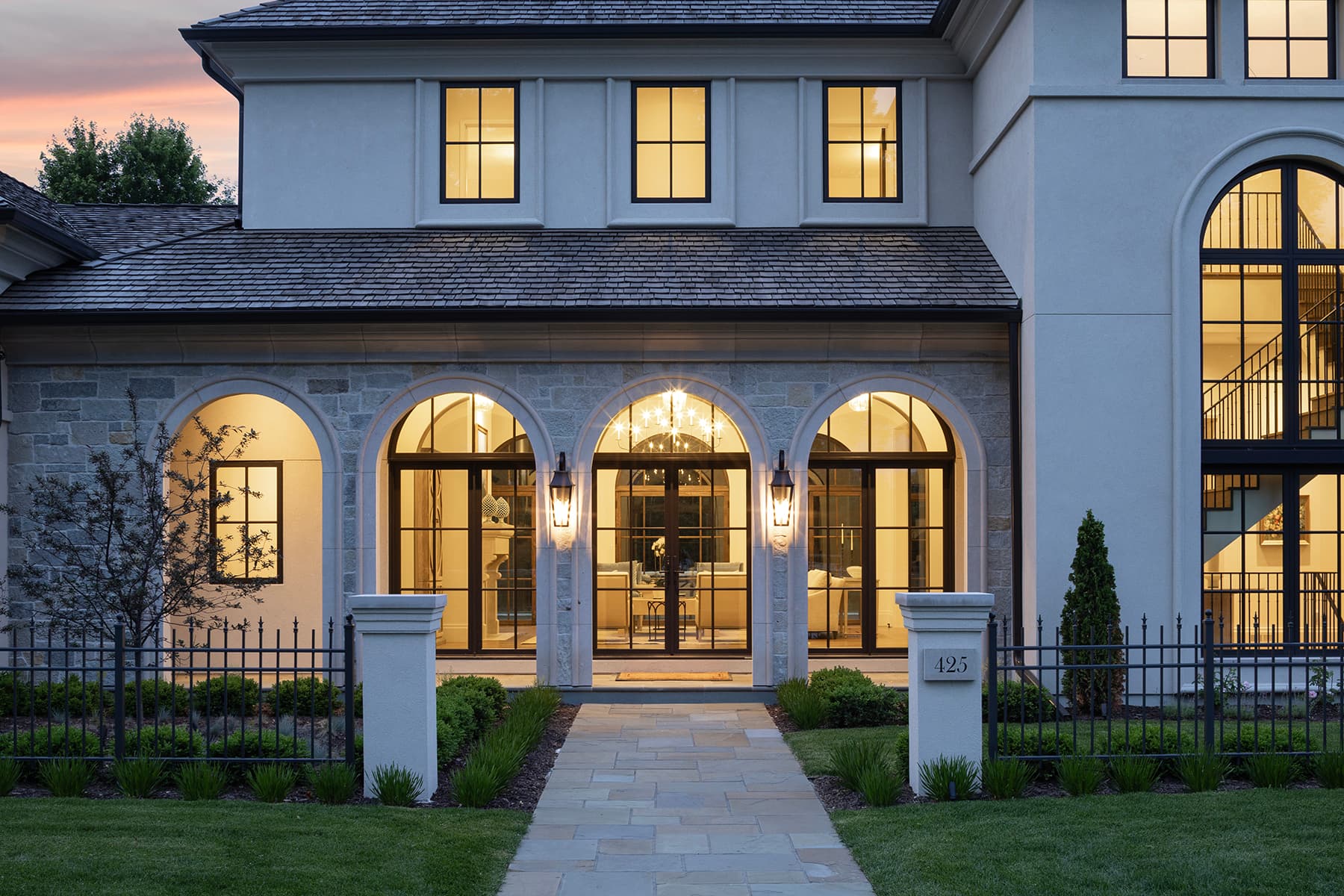 Highcroft entrance arcade illuminated beneath a rose-colored evening sky