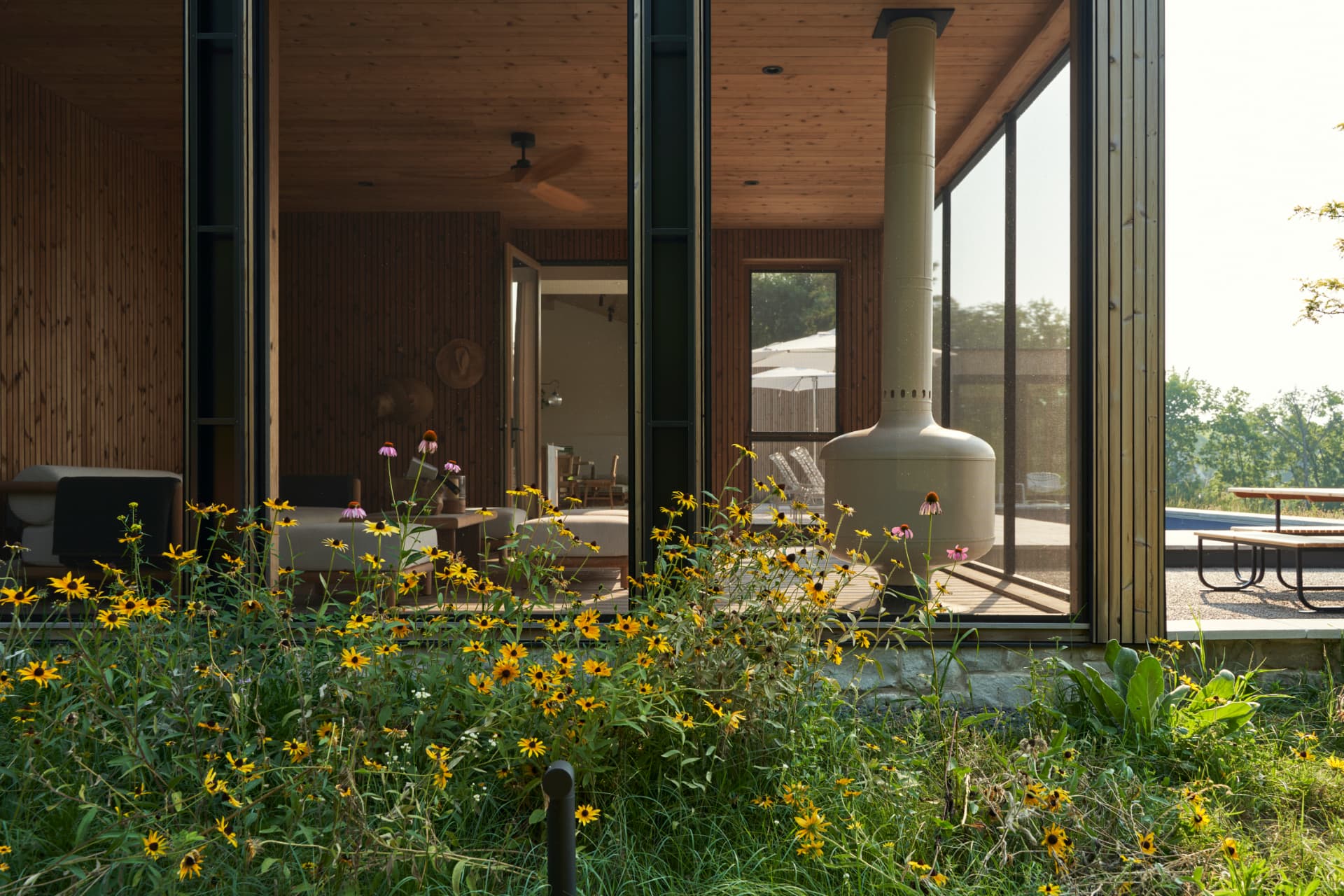 Hill House screened porch opening to the native garden