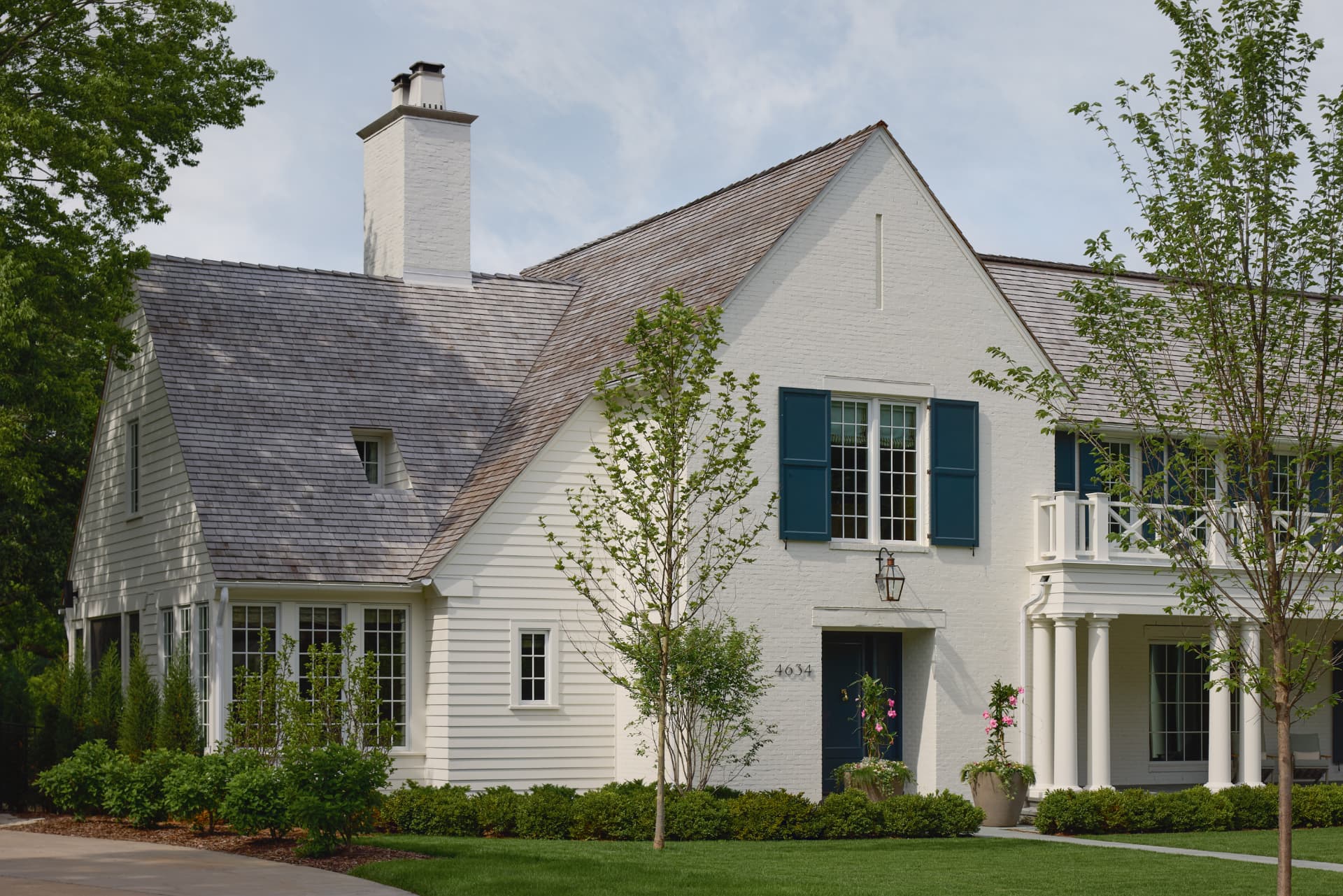 Waters Edge white brick exterior and garden