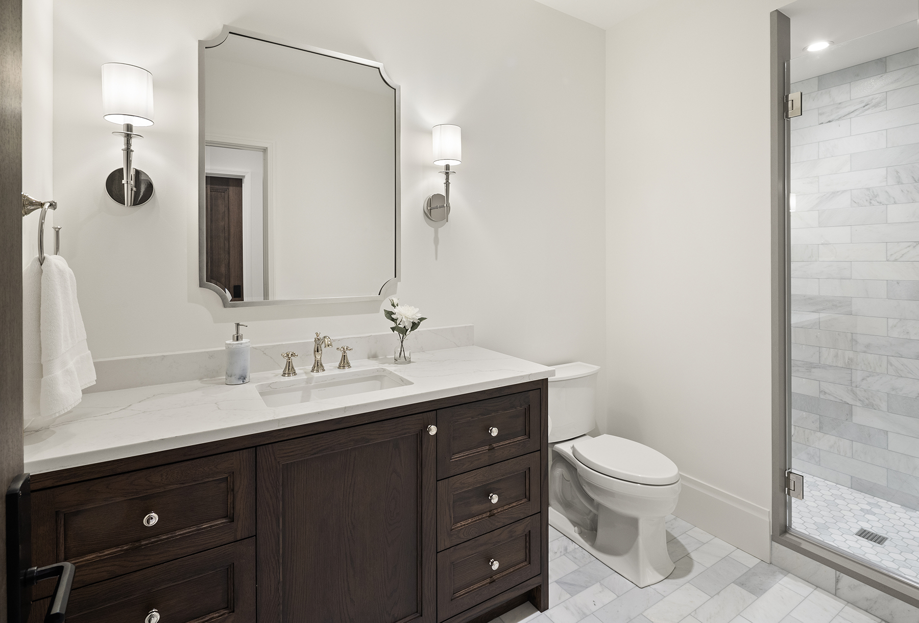 Highcroft guest bath with dark oak vanity and marble tile shower