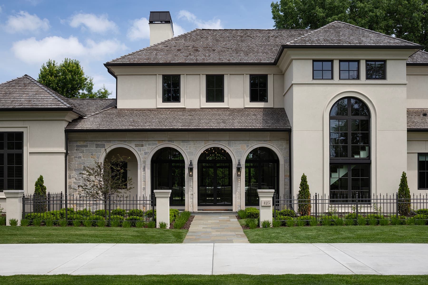 Highcroft entrance facade with stone arcade and arched stair window