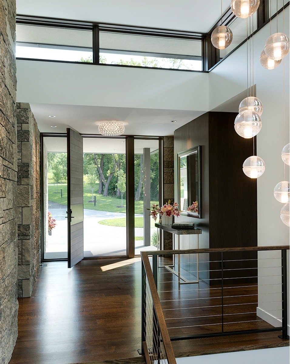 modern stone home exterior front entry and circle driveway