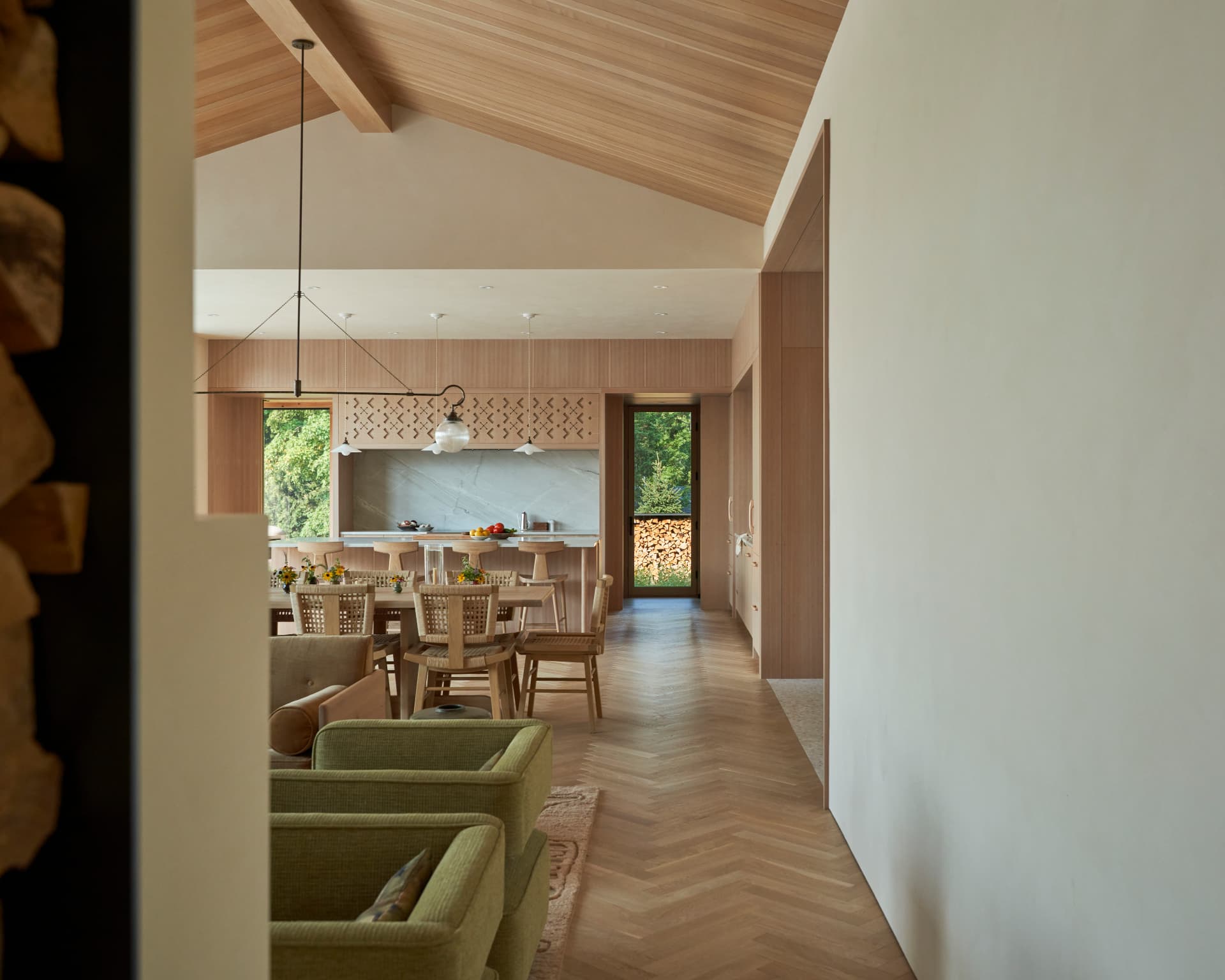 Hill House great room opening toward the kitchen and dining area