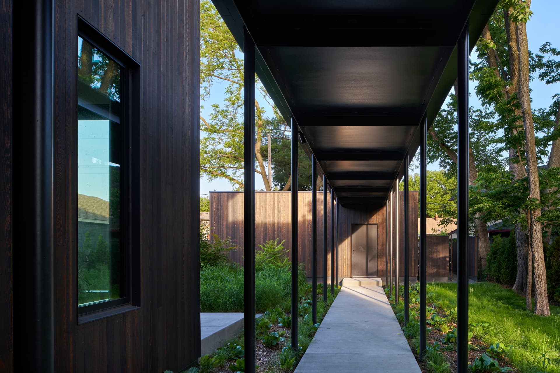 River’s Edge covered walkway framed by trees