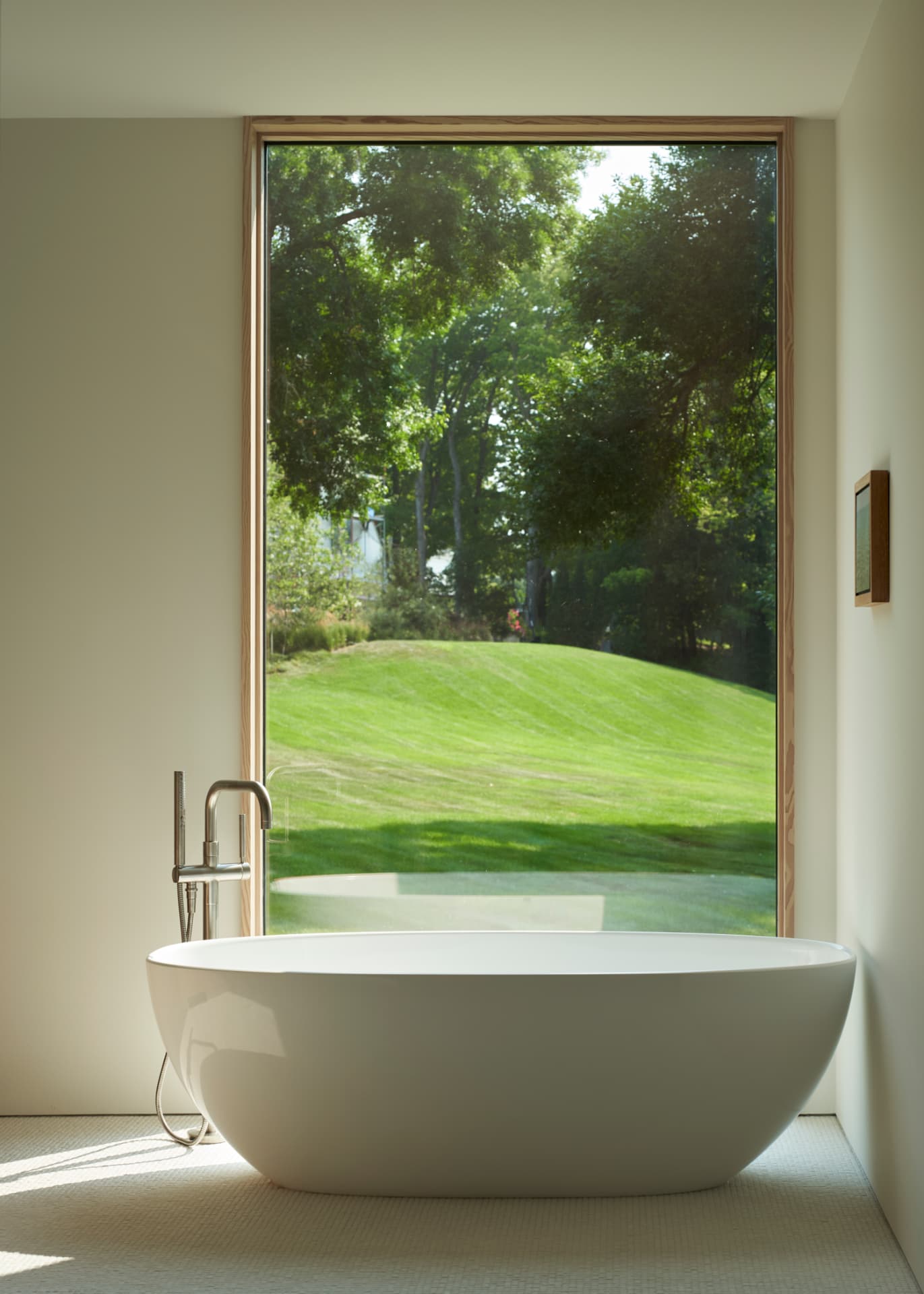 Hill House freestanding tub against a tall window