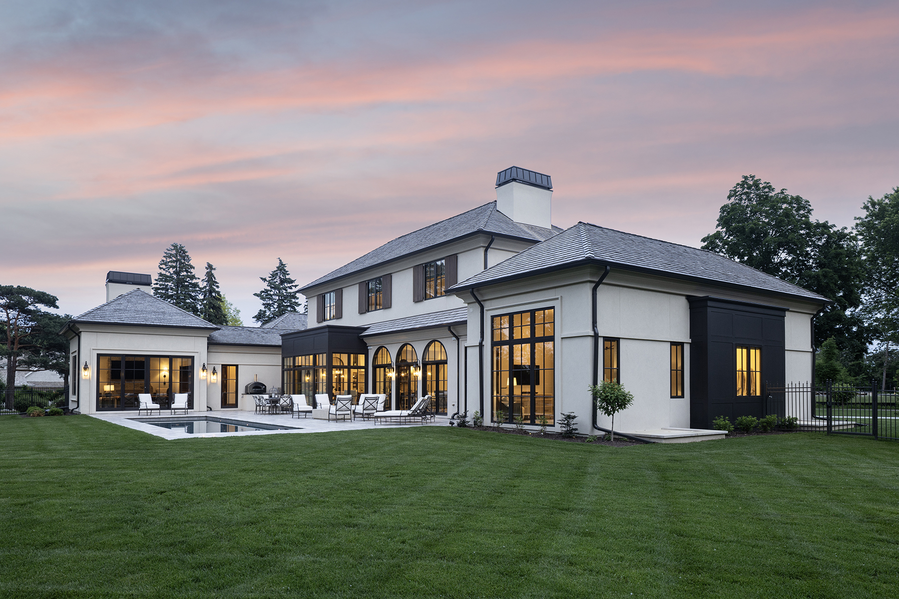 Highcroft evening exterior with slate roofs and pink sunset sky