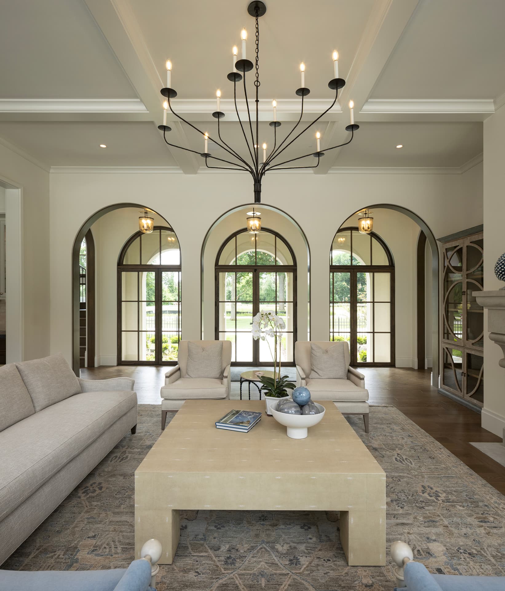 Highcroft living room beneath a coffered ceiling with triple arched garden doors