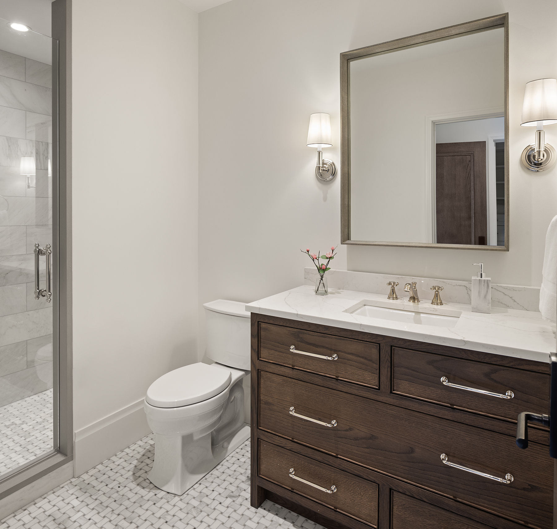 Highcroft guest bath with marble shower and basketweave tile floor