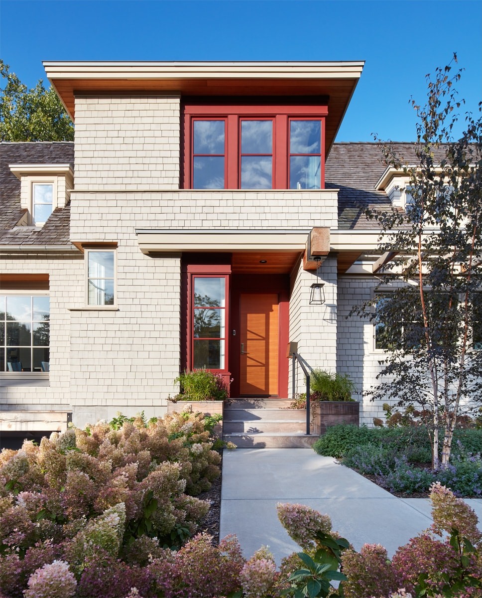 custom home contemporary cape cod with car in driveway