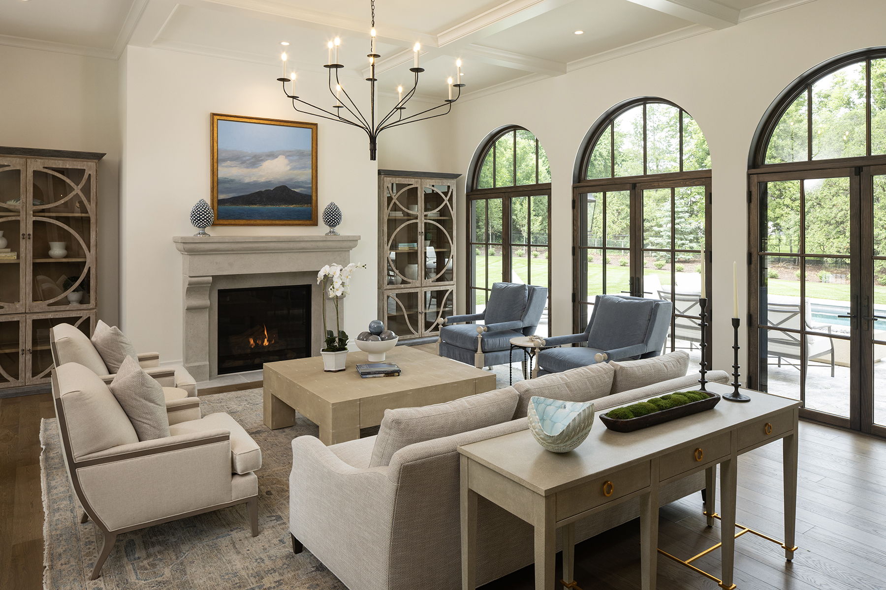 Highcroft living room with carved limestone fireplace and poolside arched doors