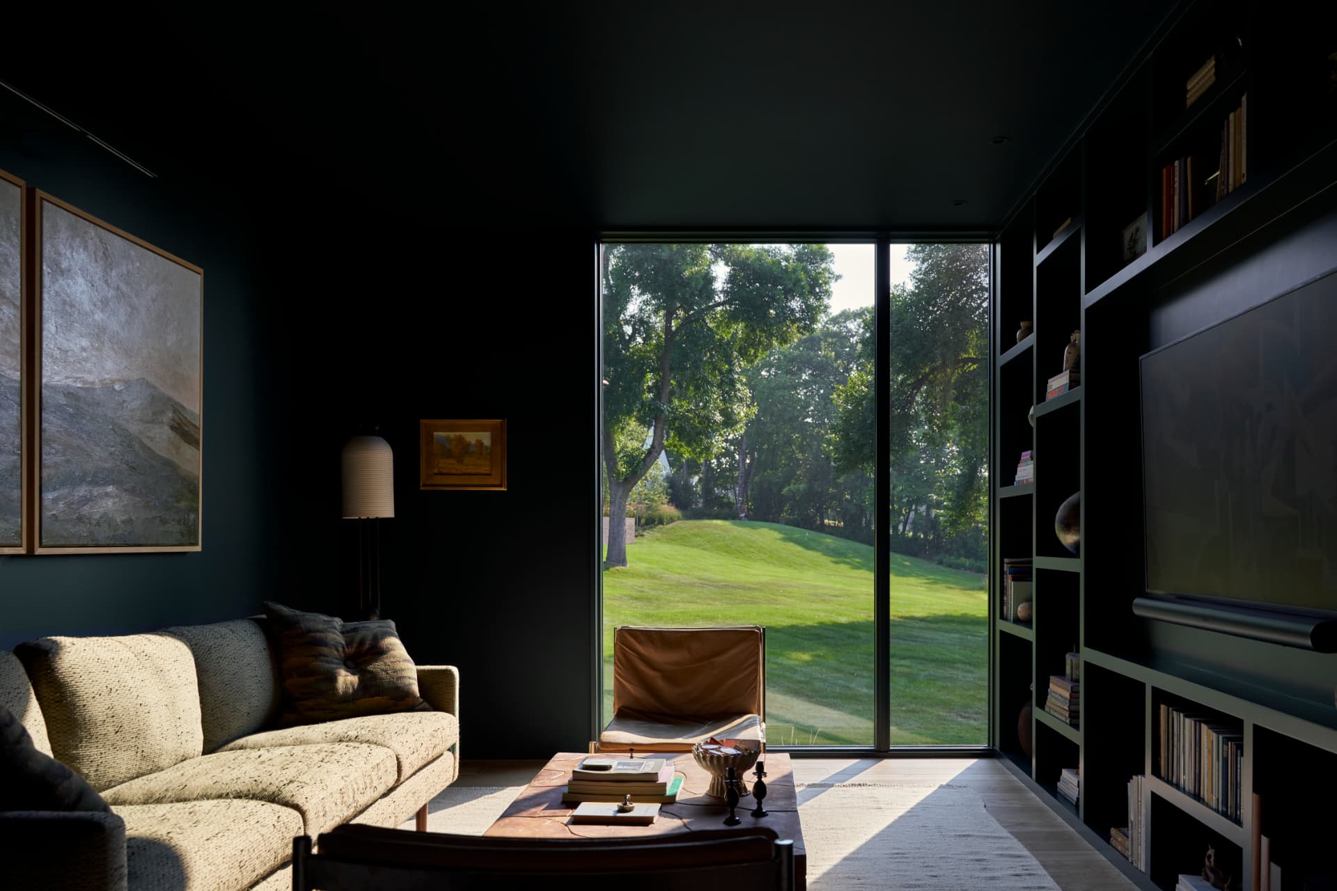 Hill House den with built-in shelving and fireplace