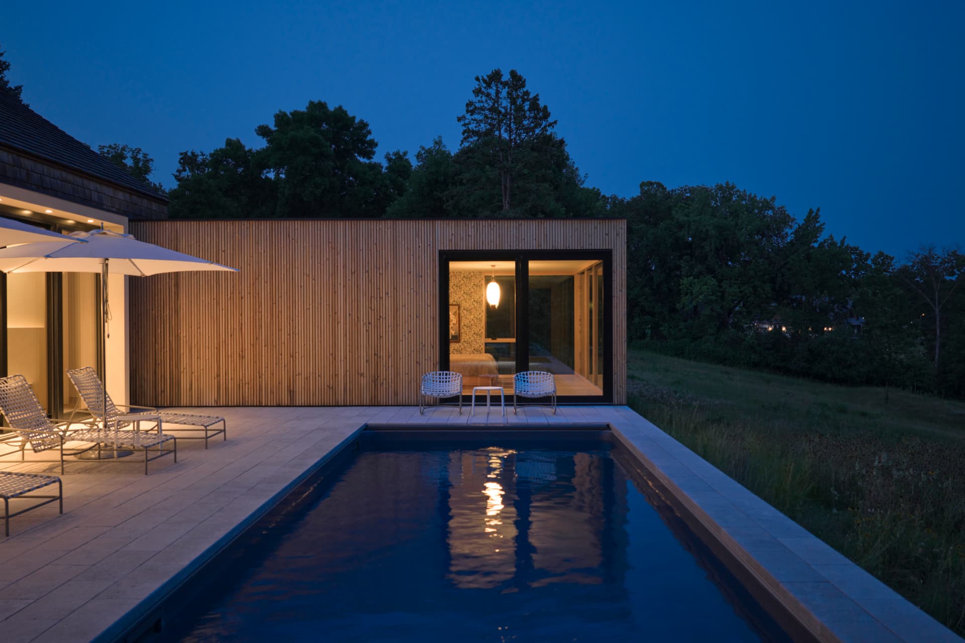 Hill House pool and cedar pavilion at night