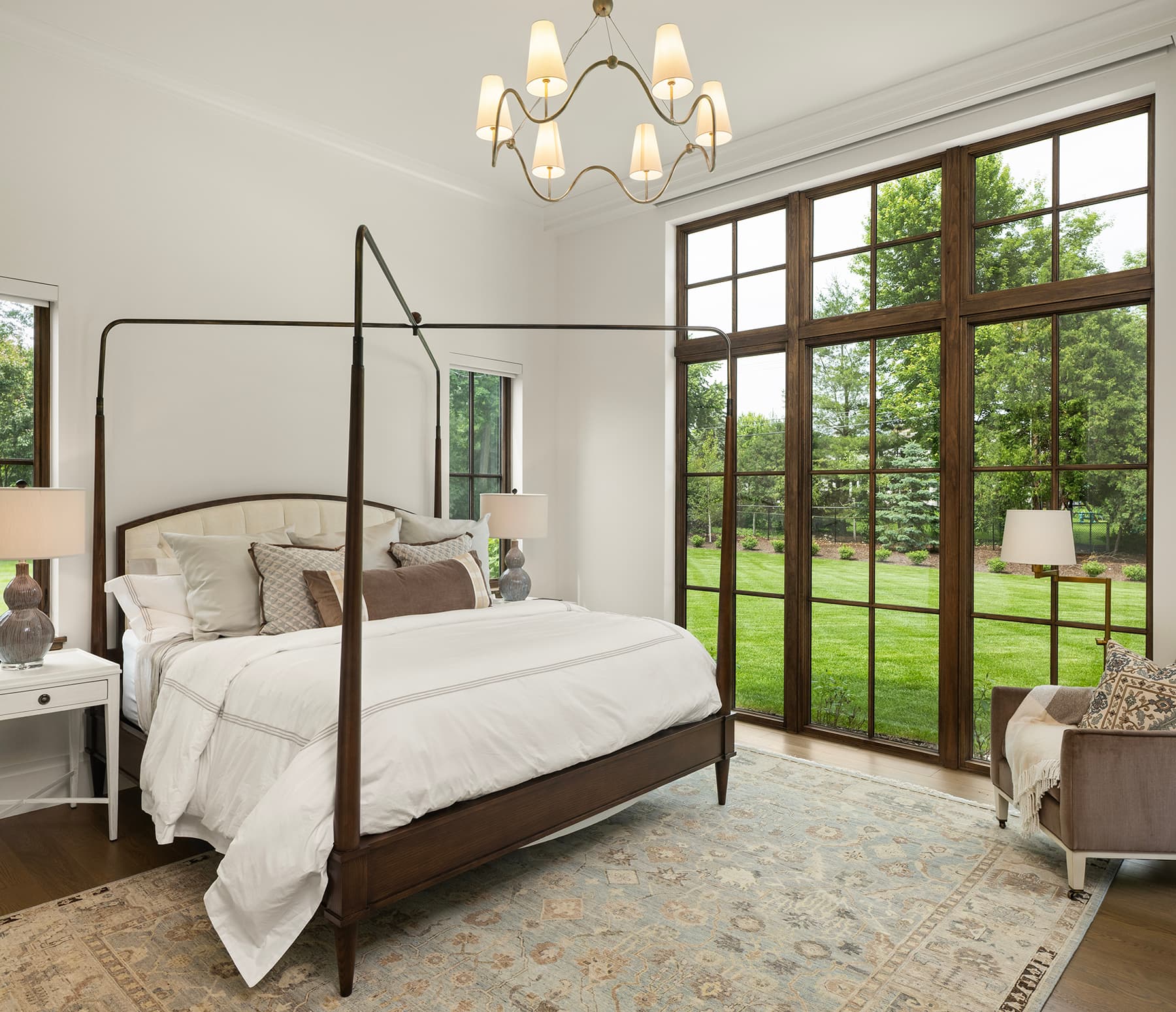 Highcroft primary bedroom with canopy bed and full-height lawn views